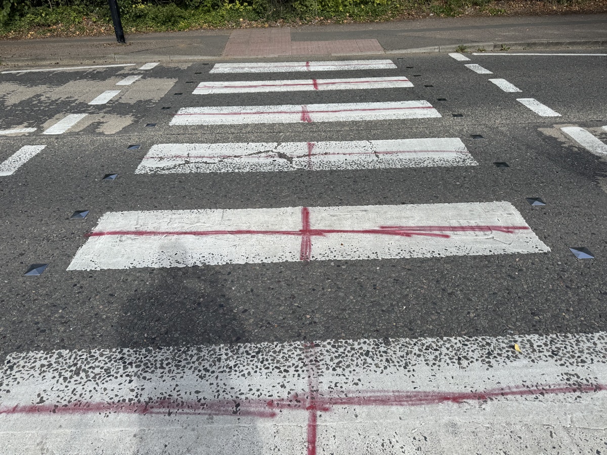 A pedestrian crossing on Shepherd's Drive in Pinewood painted with St George's Crosses